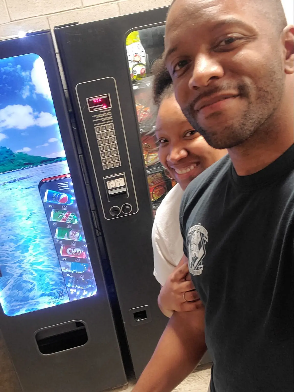 Todd and Robbyn Blackwell standing beside their first vending machines