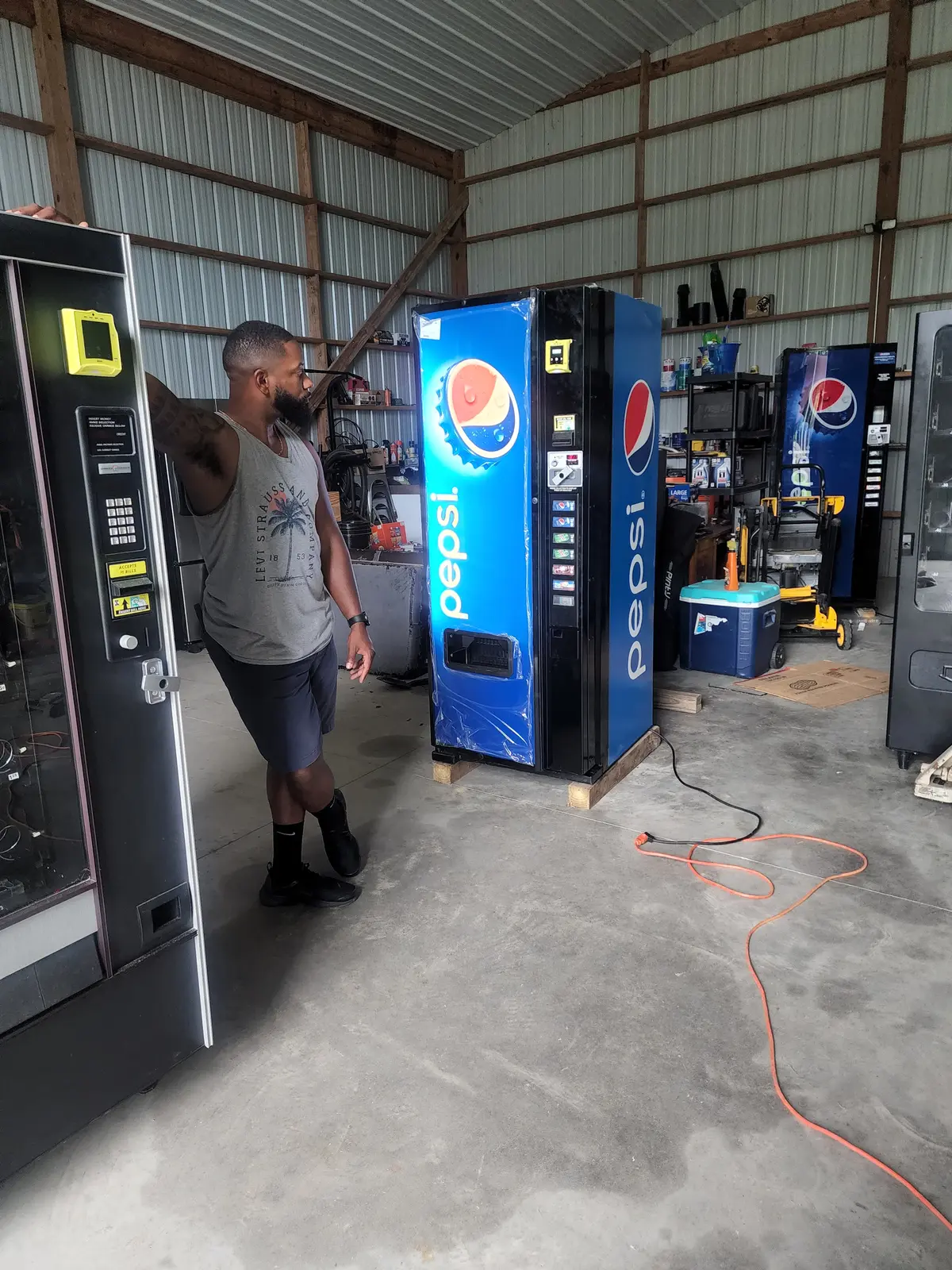 Todd Blackwell working around vending machines in a warehouse